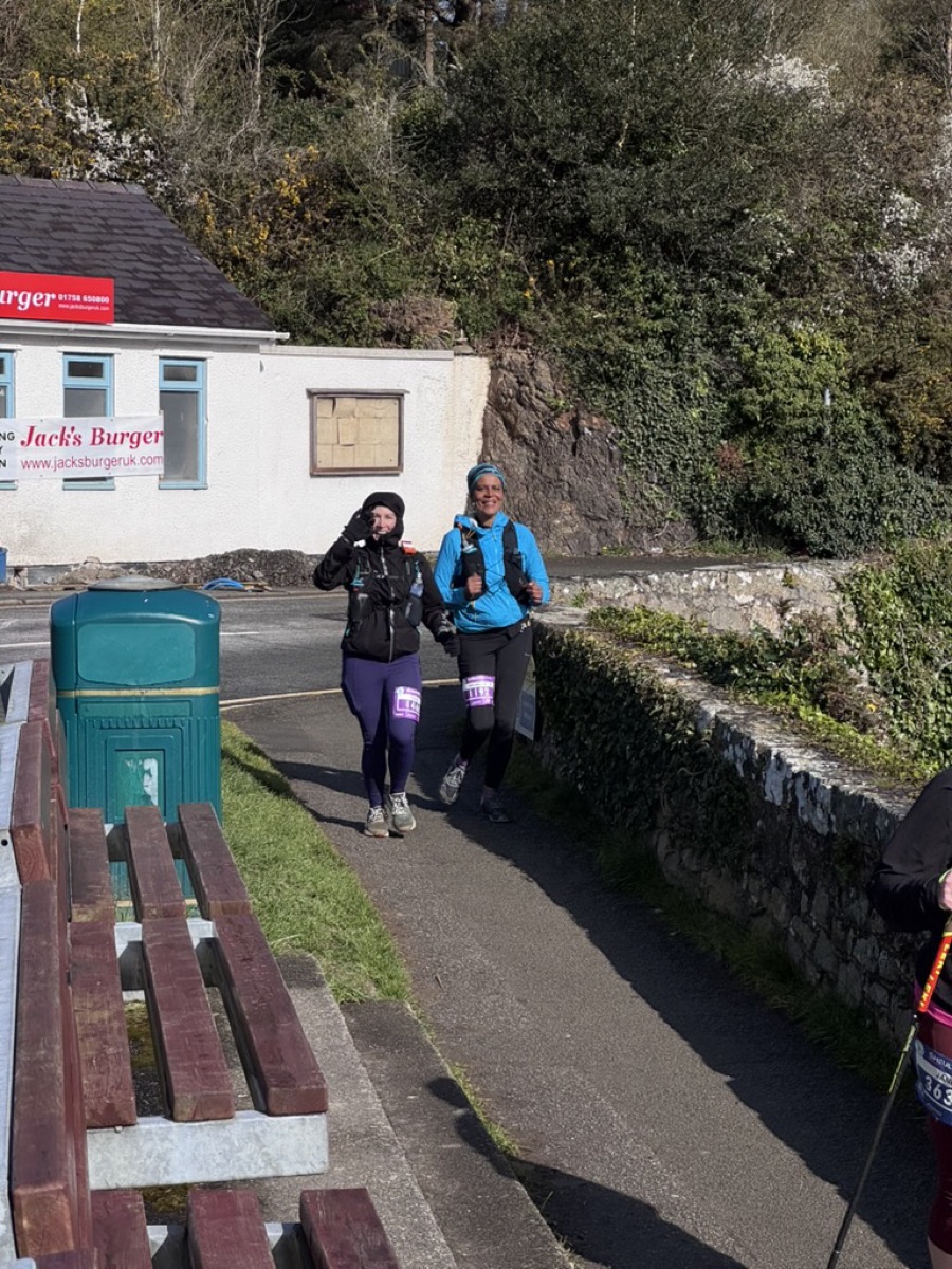 Cass and a running partner passing Jack's Burger in the sunshine